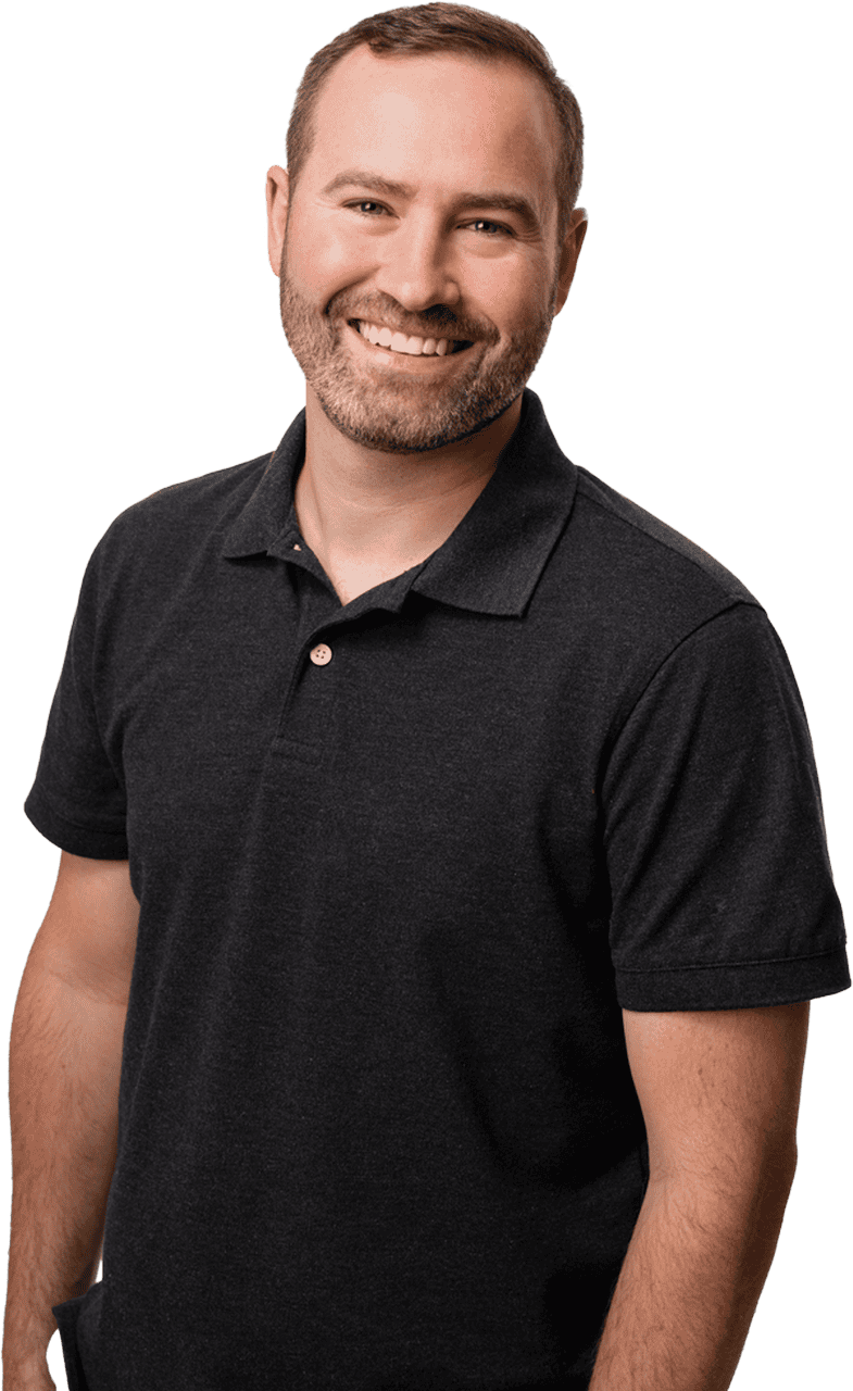 Beautiful smiling man in black polo shirt, standing confidently to promote real estate services in West Michigan.